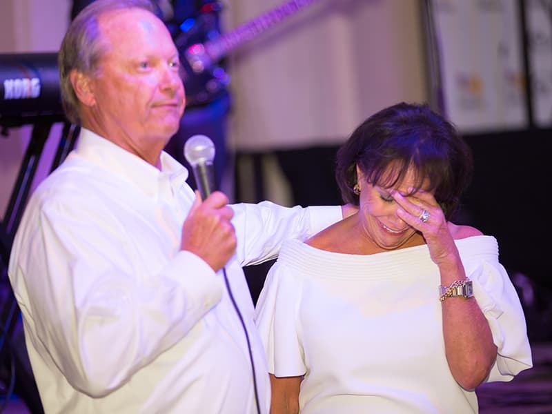 Sara Ray reacts to incoming Friends of Children's Hospital board chair Sidney Allen's announcement of naming part of future construction in her honor. Ray has been board chair of the nonprofit since 2010.