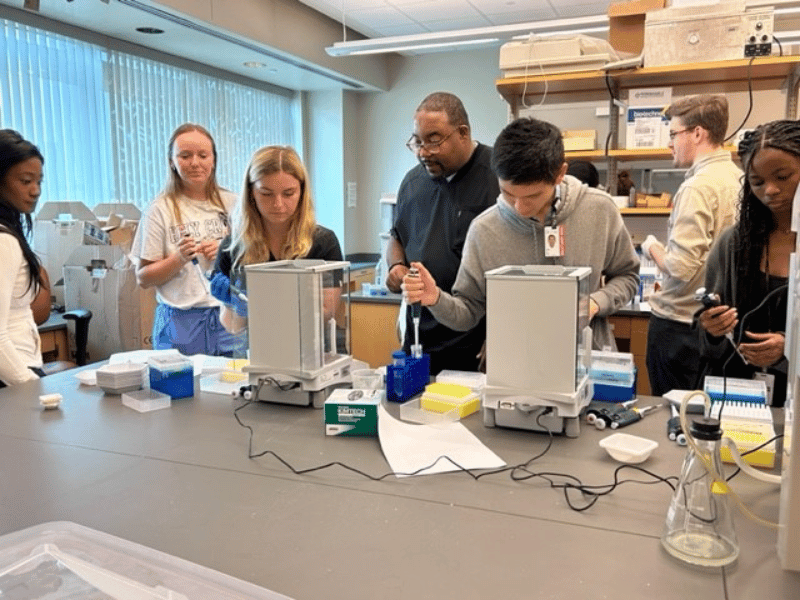 SURE students in lab doing hands-on activities.